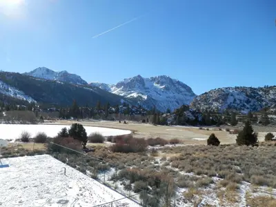 a view of a snowy field with mountains in the background at Rr-interlaken 29 in June Lake