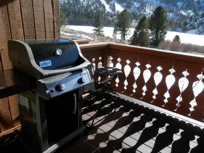 a grill on a balcony with a view of a mountain at Rr-interlaken 29 in June Lake