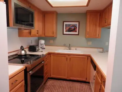 a kitchen with wooden cabinets and a sink at Rr-interlaken 29 in June Lake