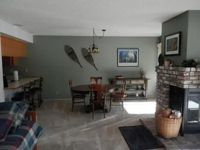 a living room with a table and a fireplace at Rr-interlaken 29 in June Lake