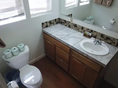 a bathroom with a toilet and a sink and a mirror at Rainbow Ridge B - 1BR/1BA in June Lake