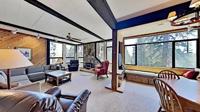 a living room with a couch and a table at Great Condo With Free Shuttle to the Village! in Mammoth Lakes