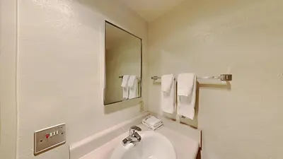 a white bathroom with a sink and a mirror at Spacious 2 Bedroom Condo with Mountain View! in Mammoth Lakes