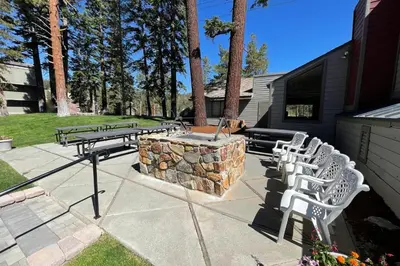 a group of picnic tables and chairs on a patio at Spacious 2 Bedroom Condo with Mountain View! in Mammoth Lakes