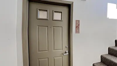 a wooden door in a room with stairs at Spacious Condo Great For Friends And Families! in Mammoth Lakes