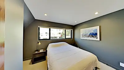 a small bedroom with a bed and a window at Beautifully remodeled 3 Bedroom Condo in Mammoth Lakes
