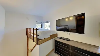 a bedroom with a bunk bed and a flat screen tv at Beautifully remodeled 3 Bedroom Condo in Mammoth Lakes