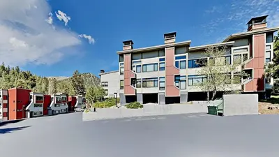a large apartment building with a parking lot at Beautifully remodeled 3 Bedroom Condo in Mammoth Lakes