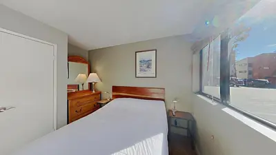a bedroom with a white bed and a window at Lakeview 826 Condo #553 Condo in Mammoth Lakes