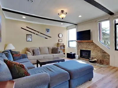 a living room with a couch and a fireplace at Walk To Lifts! Remodeled 2 Bedroom Condo in Mammoth Lakes