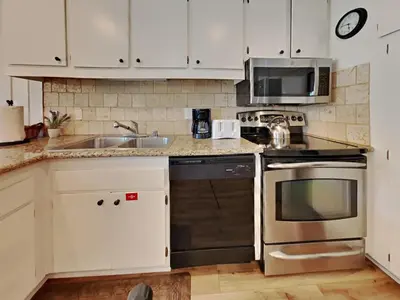 a kitchen with a sink and a stove and a microwave at Walk To Lifts! Remodeled 2 Bedroom Condo in Mammoth Lakes