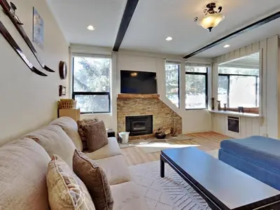 a living room with a couch and a fireplace at Walk To Lifts! Remodeled 2 Bedroom Condo in Mammoth Lakes