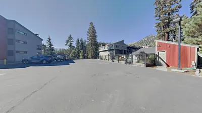 an empty parking lot with a car parked on the street at Remodeled Spacious Cozy Condo Great For Families! in Mammoth Lakes