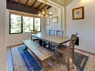 a dining room with a wooden table and chairs at Remodeled Spacious Cozy Condo Great For Families! in Mammoth Lakes