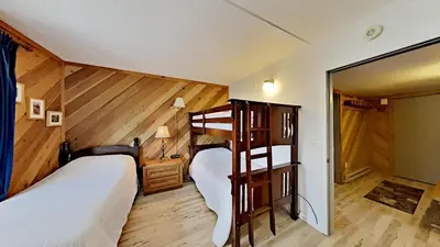 two bunk beds in a room with wooden walls at Great 3 Bedroom Condo with Washer and Dryer! in Mammoth Lakes