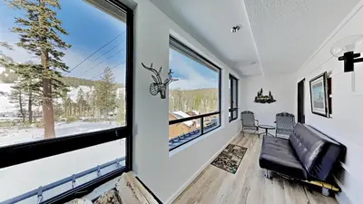 a living room with a couch and large windows at Great 3 Bedroom Condo with Washer and Dryer! in Mammoth Lakes