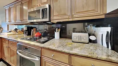 a kitchen with wooden cabinets and a counter top at Beautiful 2 Bedroom Condo with Amazing View! in Mammoth Lakes