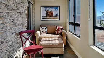 a living room with a couch and a chair at Beautiful 2 Bedroom Condo with Amazing View! in Mammoth Lakes