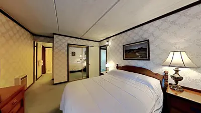 a bedroom with a large white bed and a lamp at Retro 3 Bed 3 Bath Condo with Mountain View! in Mammoth Lakes