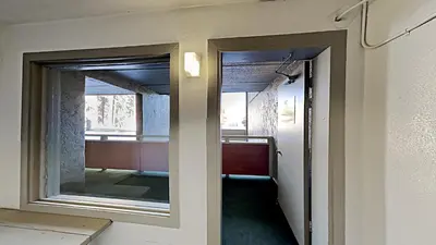 a hallway with a mirror and a window in a room at Retro 3 Bed 3 Bath Condo with Mountain View! in Mammoth Lakes