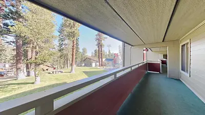 a balcony with a view of a yard at Great 2 Bedroom Condo with Mountain View! in Mammoth Lakes