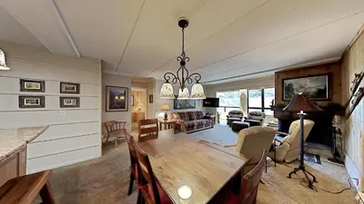 a living room with a table and a dining room at 2 Bed 2 Bath Condo Steps Away From Recreation! in Mammoth Lakes