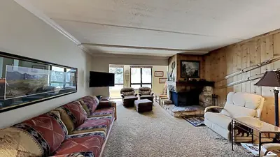 a living room with a couch and a fireplace at 2 Bed 2 Bath Condo Steps Away From Recreation! in Mammoth Lakes