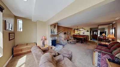 a living room with a couch and a fireplace at 2 Bed 2 Bath Condo Steps Away From Recreation! in Mammoth Lakes
