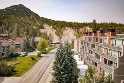 an empty street in a town with a mountain at 2 Bed 2 Bath Condo Steps Away From Recreation! in Mammoth Lakes