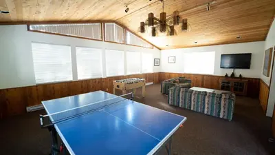 a large room with a ping pong table in it at 2 Bed 2 Bath Condo Steps Away From Recreation! in Mammoth Lakes