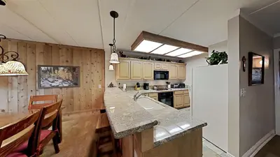 a kitchen with a sink and a refrigerator at 2 Bed 2 Bath Condo Steps Away From Recreation! in Mammoth Lakes
