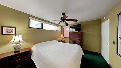 a bedroom with a bed and a ceiling fan at Beautifully Remodeled 4 Bedroom Condo in Mammoth Lakes