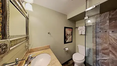 a bathroom with a sink and a toilet and a shower at Beautifully Remodeled 4 Bedroom Condo in Mammoth Lakes