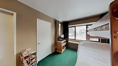 a bedroom with a bunk bed and a window at Beautifully Remodeled 4 Bedroom Condo in Mammoth Lakes