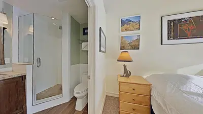 a bedroom with a shower and a bed and a toilet at Beautiful 4 Bed Condo with Top Of The Hill Views! in Mammoth Lakes