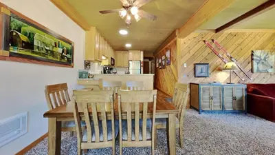 a dining room and kitchen with a table and chairs at Nicely Remodeled 2 Bedroom Condo in Mammoth! in Mammoth Lakes