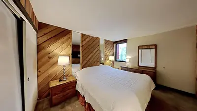 a bedroom with a white bed and a mirror at Cozy 4-Bedroom Home with Pool and Mountain View! in Mammoth Lakes