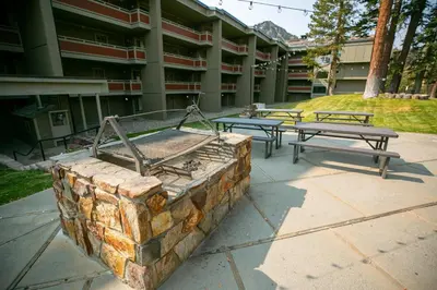 a group of picnic tables in front of a building at Cozy 4-Bedroom Home with Pool and Mountain View! in Mammoth Lakes