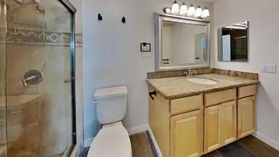 a bathroom with a toilet and a sink and a shower at Large Spacious Upgraded 4 Bedroom Condo in Mammoth Lakes