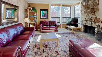a living room with a couch and a fireplace at Upgraded 2 Bedroom Condo with Pool in Mammoth Lakes