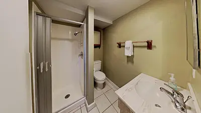 a bathroom with a shower and a toilet and a sink at Upgraded 2 Bedroom Condo with Pool in Mammoth Lakes