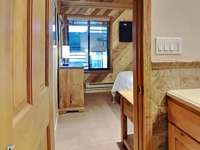 a small room with a bed and a window at Lakeview 826 Condo #302 Condo in Mammoth Lakes