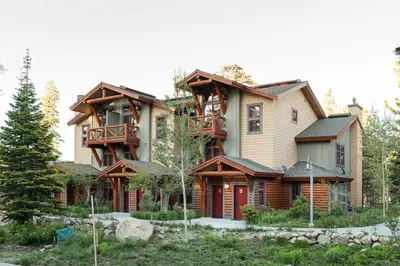 a large wooden house with a balcony at Cabins 13 in Old Mammoth