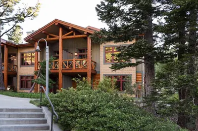 a house with a deck on the side of it at Cabins 13 in Old Mammoth