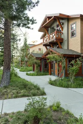 a house with a walkway in front of a building at Cabins 13 in Old Mammoth