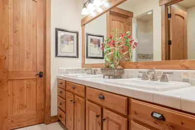 a bathroom with two sinks and a large mirror at Lodges 1140- Spacious Townhome on Golf Course in Old Mammoth