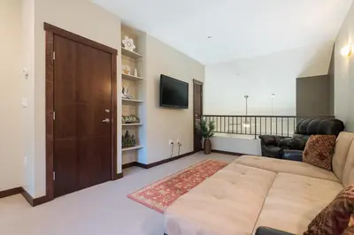 a living room with a couch and a television at Solstice 21 in Mammoth Lakes
