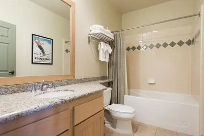 a bathroom with a sink and a tub and a toilet at Sunstone 325 in Old Mammoth