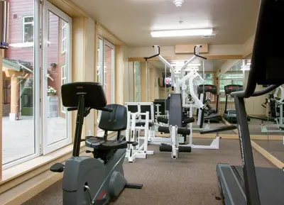 a gym with treadmills and machines in a building at Sunstone 325 in Old Mammoth
