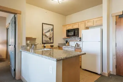 a kitchen with a white refrigerator and a sink at Sunstone 325 in Old Mammoth